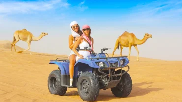 Tourist riding a quad bike in the Hurghada desert with mountains in the background