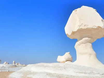White Desert in Egypt with unique chalk rock formations under a blue sky