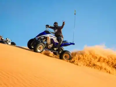 Desert Quad Bike in Sharm El Sheikh adventure racing through golden sand dunes under a sunny sky