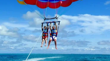 Tourists enjoying parasailing over the Red Sea during a Hurghada adventure