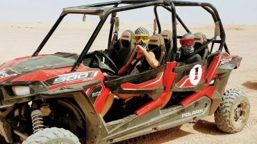 Buggy Bike Sharm El Sheikh racing across golden desert dunes with mountains in the background