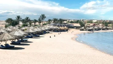 Sharm El Naga Bay Beach with golden sand, turquoise water, and coral reefs