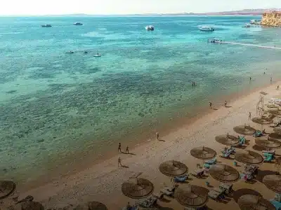 Sharm El Naga Bay Beach with golden sand, turquoise water, and coral reefs