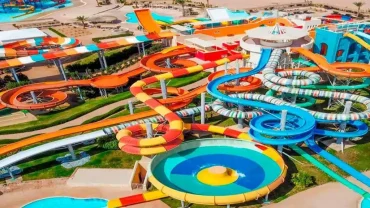 Colorful water slides and pools at Jungle Aqua Park in Hurghada with people enjoying a sunny day