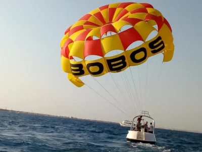 Parasailing over the turquoise Red Sea in Hurghada with a parachute attached to a speedboat