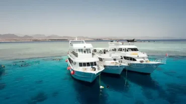 Family on a private boat in the Red Sea fishing and snorkeling together