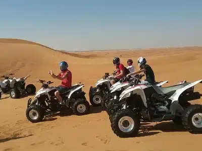Desert Quad Bike in Sharm El Sheikh adventure racing through golden sand dunes under a sunny sky
