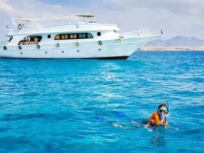 Family on a private boat in the Red Sea fishing and snorkeling together