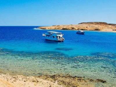 Ras Mohamed National Park guide showing coral reefs, turquoise waters, and desert mountains under sunny skies