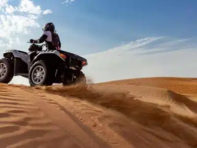 Desert Quad Bike in Sharm El Sheikh adventure racing through golden sand dunes under a sunny sky