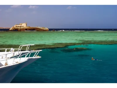 Tiran Island Boat Trip Sharm El Sheikh with tourists snorkeling over coral reefs in turquoise waters