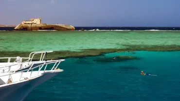 Family on a private boat in the Red Sea fishing and snorkeling together