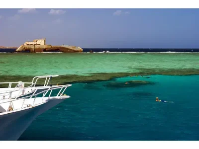 as Mohamed & White Island Boat Trip with tourists snorkeling in turquoise waters surrounded by coral reefs