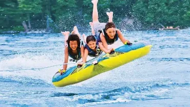 Water Sports Adventure in Sharm El Sheikh with people parasailing, diving, and jet skiing in the Red Sea