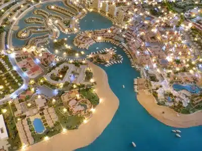 Port Ghalib shopping area with colorful boutiques, waterfront cafes, and tourists browsing souvenirs