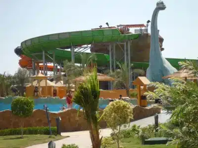 Colorful water slides and pools at Jungle Aqua Park in Hurghada with people enjoying a sunny day