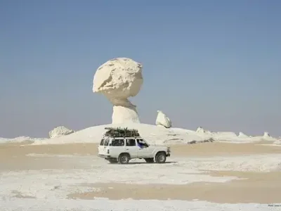 White Desert in Egypt with unique chalk rock formations under a blue sky