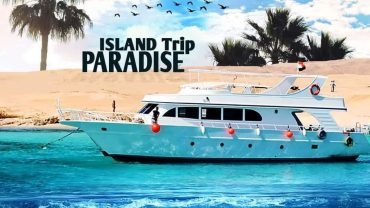 Tourists relaxing on the sandy beach during a Paradise Island Boat Trip Package in Hurghada