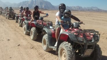 Family enjoying a Private Safari in Hurghada with camels, jeeps, and desert sunset
